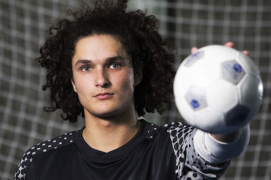 Futsal player Riley Battle holds a futsal ball photographed by Josh Brightman Balanced Image Studio